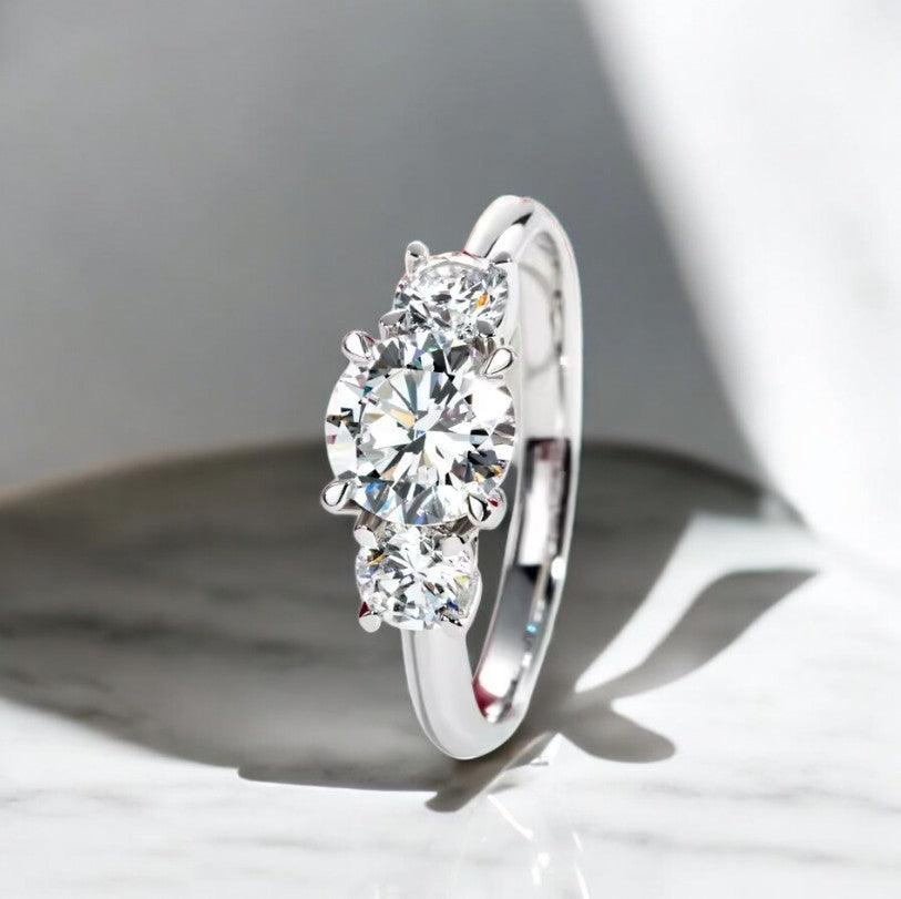 3 Stone design engagement ring with lab cultivated diamonds sparking, 14 karat white gold