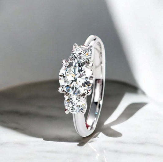 3 Stone design engagement ring with lab cultivated diamonds sparking, 14 karat white gold