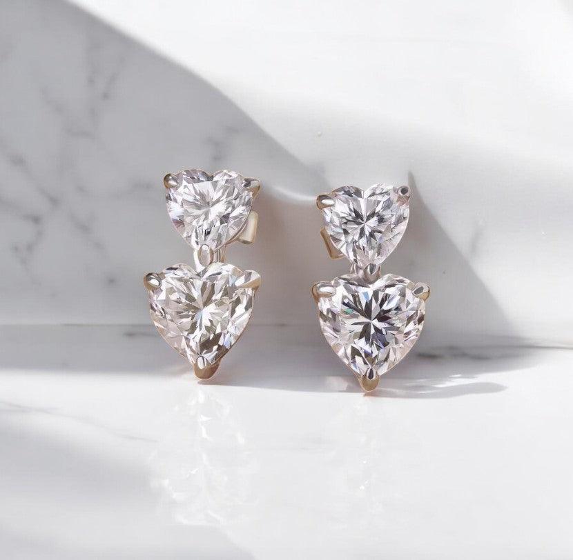 heart shaped moissanite earrings with double stack design, sitting on a marble countertop, made with sterling silver by russmoon