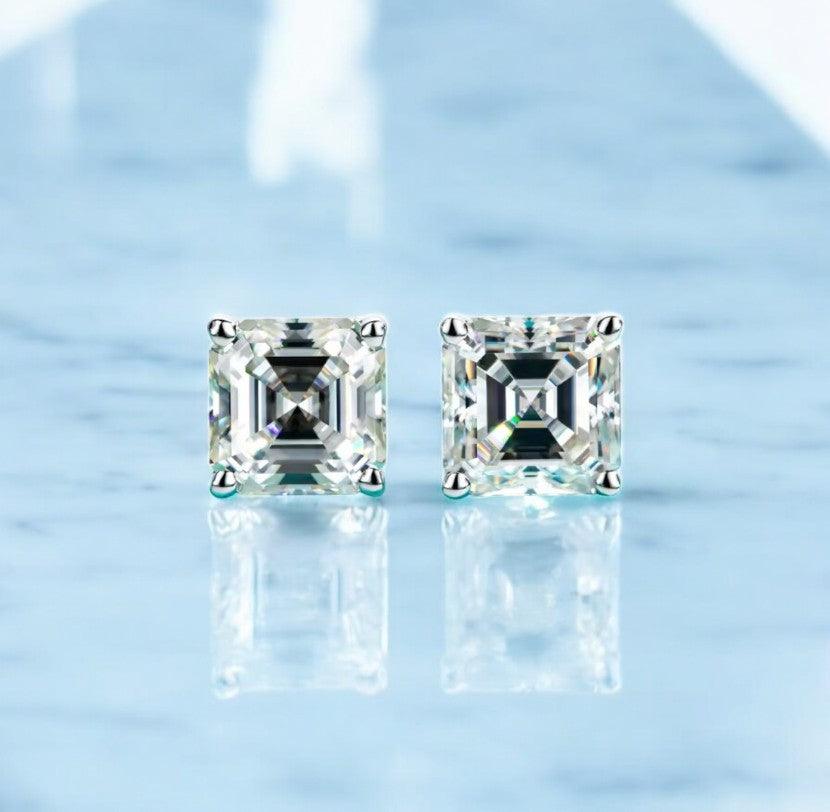 Square cut stud moissanite earrings made for both teen girls and women, displayed on a white marble counter with light blue hues, made by russmoonco