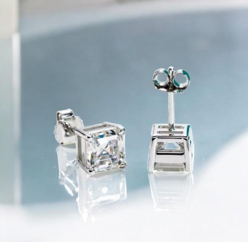 Square cut stud moissanite earrings made for both teen girls and women, displayed on a white marble counter with light blue hues, made by russmoonco