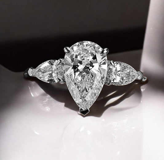 Waterdrop moissanite engagement ring with 925 sterling silver, one main stone with 2 side stones, sparking moissanite